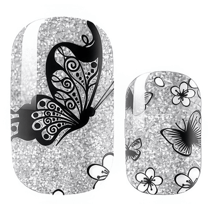Silver glitter nail wraps with black butterfly patterns for elegant at-home manicure