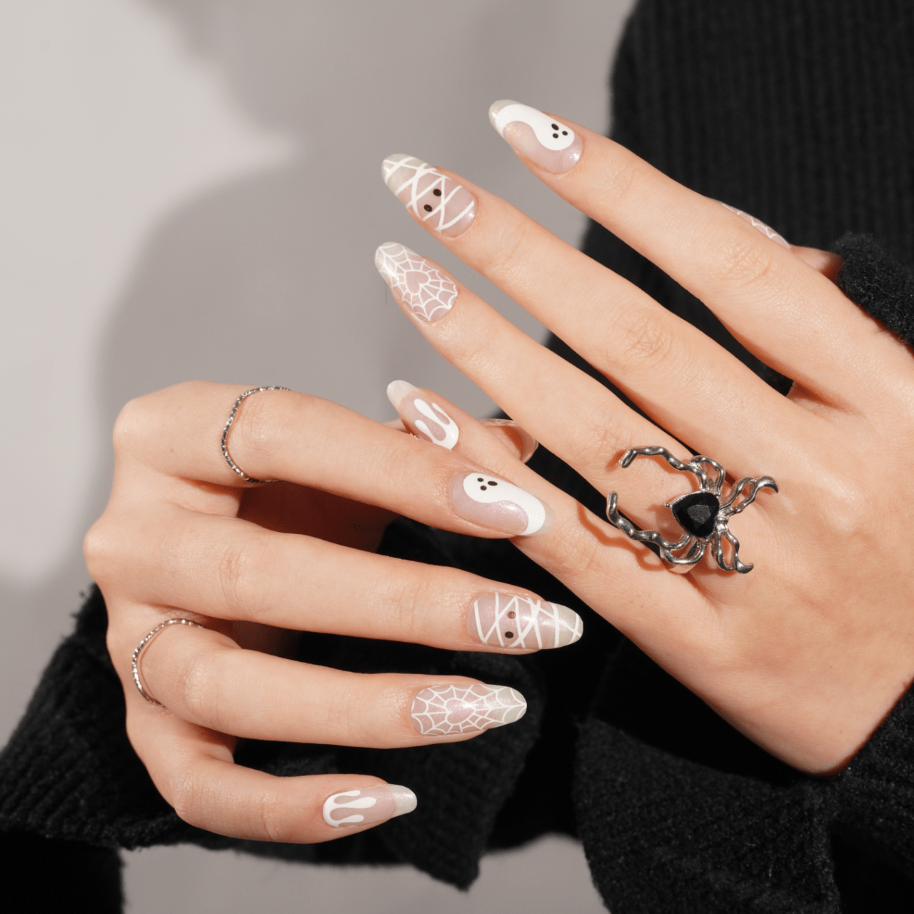 Clear Halloween gel nail wraps with ghost design on manicured hands spooky nail art