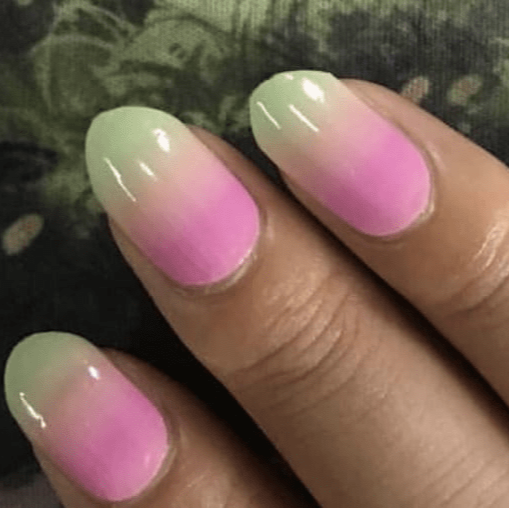 Pink green gradient ombre gel nail wraps on hand showing colour-changing hypercolour effect