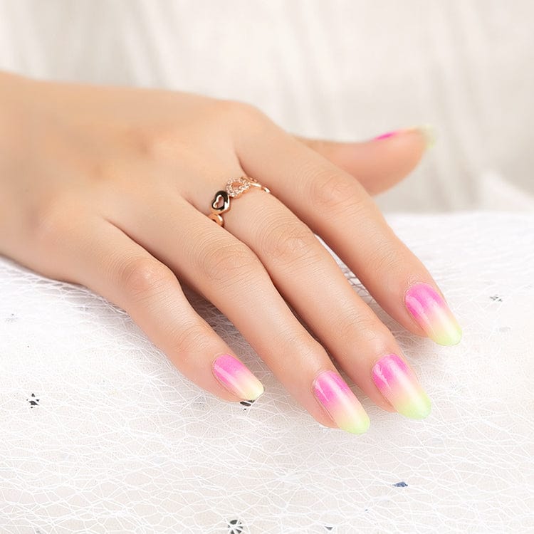 Hand wearing multicolour gradient nail wraps pink yellow green ombre at-home manicure design