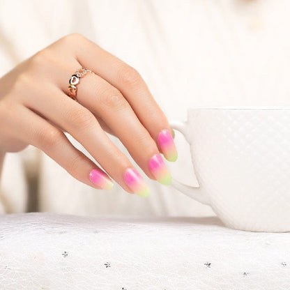 Hand with pink yellow green gradient nail wraps hypercolour ombre manicure design