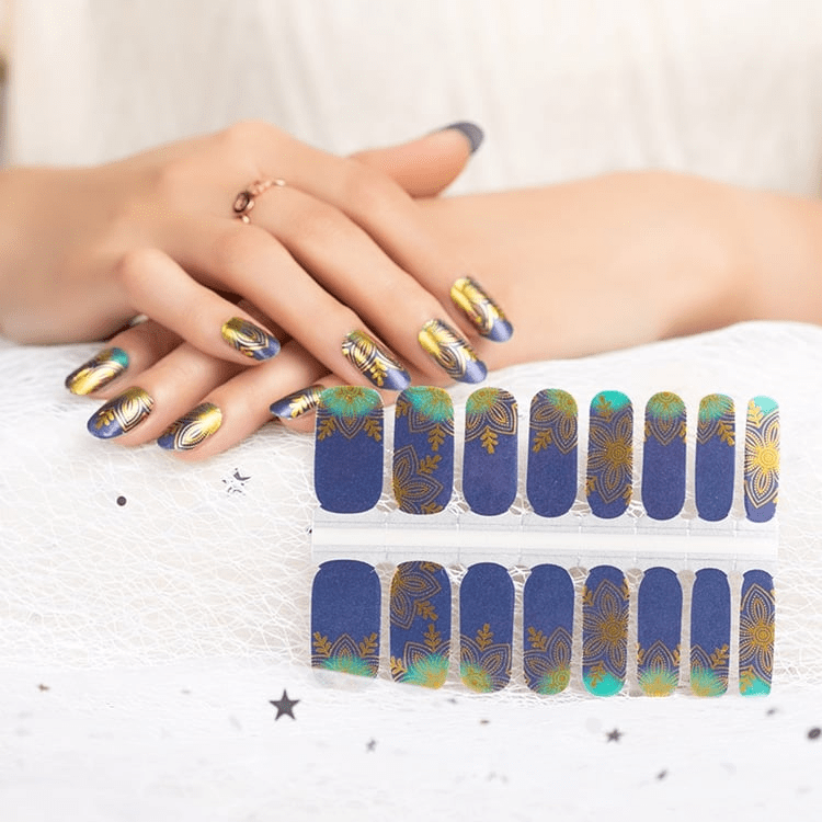 Non-UV nail wraps sheet in navy blue with golden lotus art nouveau design showing individual nail strips