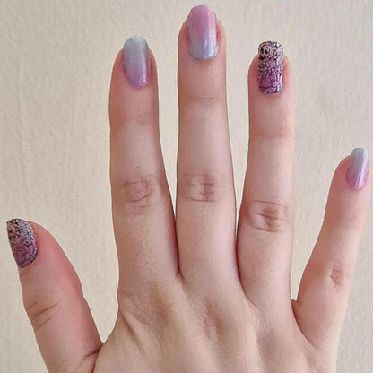 Gothic nail wraps featuring purple ombre and black lace glitter design on fingers