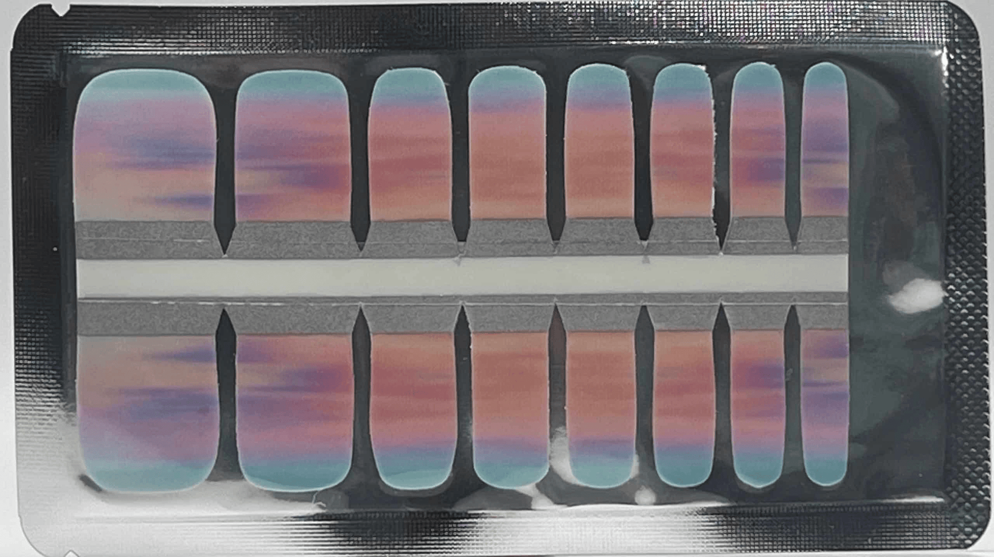 Sheet of pink to blue gradient pedicure nail wraps showing ombre sunset design