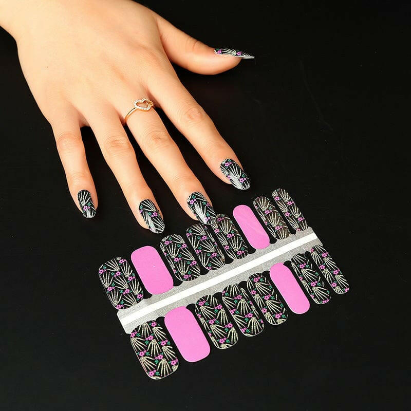 Non-UV nail wraps sheet showing skeleton bone pattern with pink accent strips