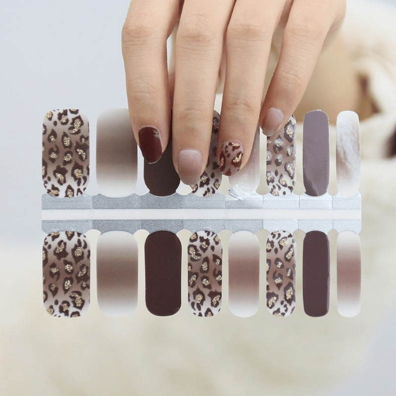 Brown leopard print nail wrap strips showing glossy animal print design patterns