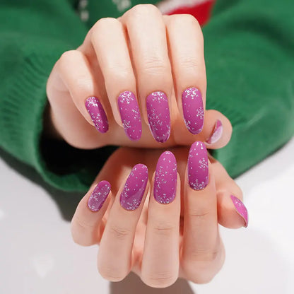 Purple sparkly Christmas nail wraps with snowflakes applied on both hands manicure