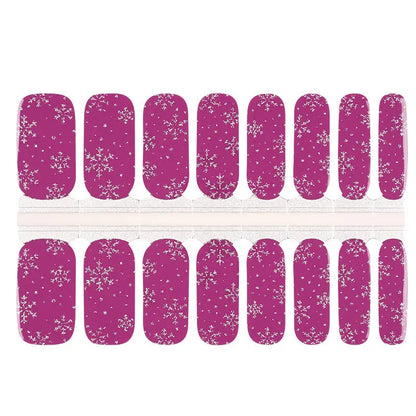 Purple sparkle Christmas nail wraps featuring white snowflake patterns for holiday nail art