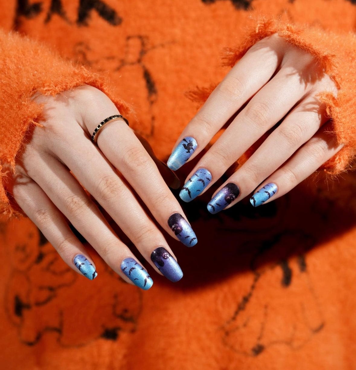 Halloween bat nail wraps in blue gradient with spooky silhouettes on both hands