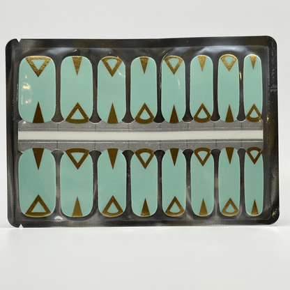 Teal non-UV nail wraps with gold art deco triangular design in packaging