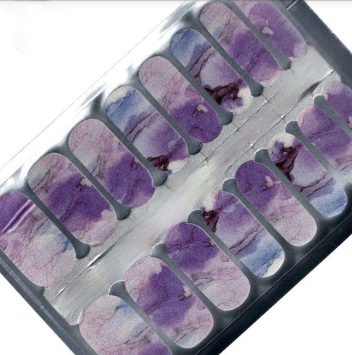 Purple marble nail wrap sheet showing individual strips with artistic stone veining patterns