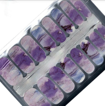 Purple marble nail wrap sheet showing individual strips with artistic stone veining patterns