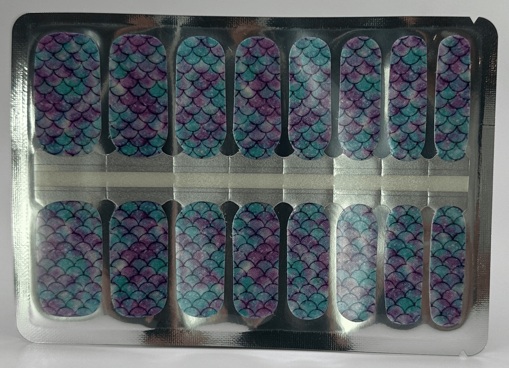Sheet of iridescent mermaid scale nail wraps in blue purple holographic pattern