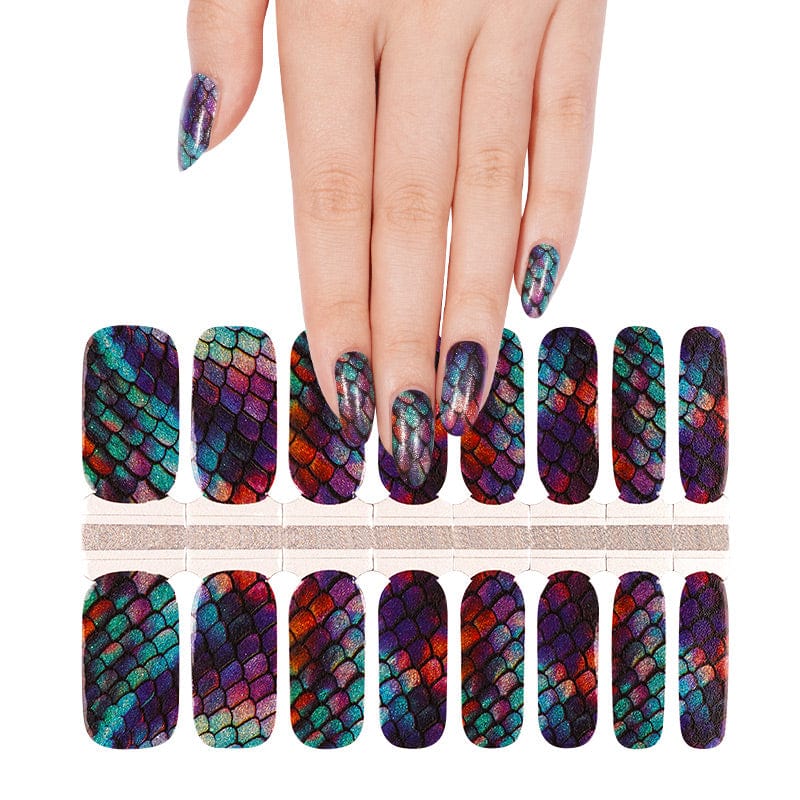 Hand wearing holographic mermaid scale nail wraps with shimmering multicolour finish