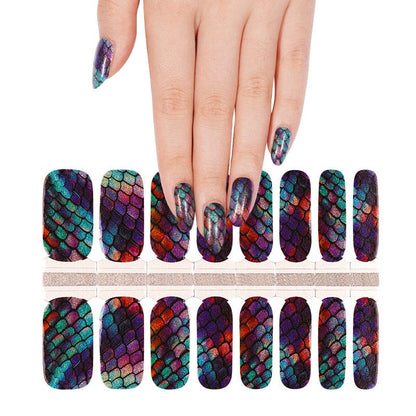 Hand wearing holographic mermaid scale nail wraps with shimmering multicolour finish