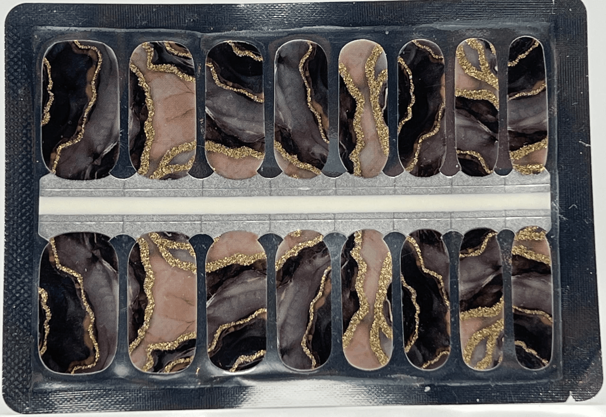 Metamorphic marble nail wraps sheet showing black and rose gold stone pattern designs