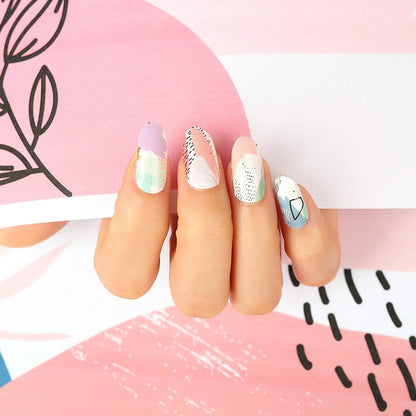 Hand displaying abstract pastel nail wraps with watercolour brushstroke design in pink and mint