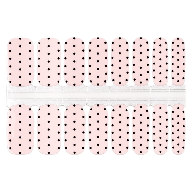 White and black polka dot nail wraps sheet displaying classic minimalist nail art pattern