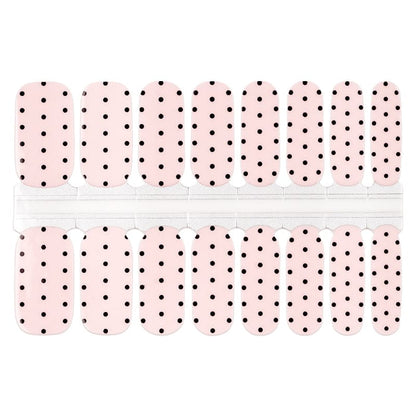 White and black polka dot nail wraps sheet displaying classic minimalist nail art pattern