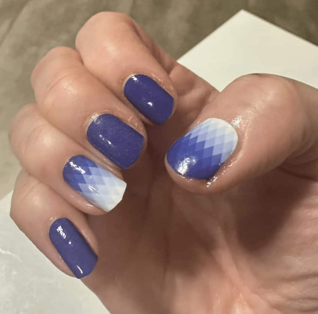 Glossy blue ombre nail wraps on hand with white gradient at-home manicure finish