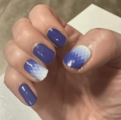 Glossy blue ombre nail wraps on hand with white gradient at-home manicure finish