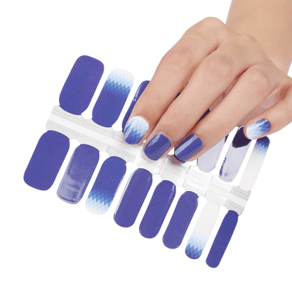 Blue and white gradient nail wraps with ombre effect shown on hand and sheet