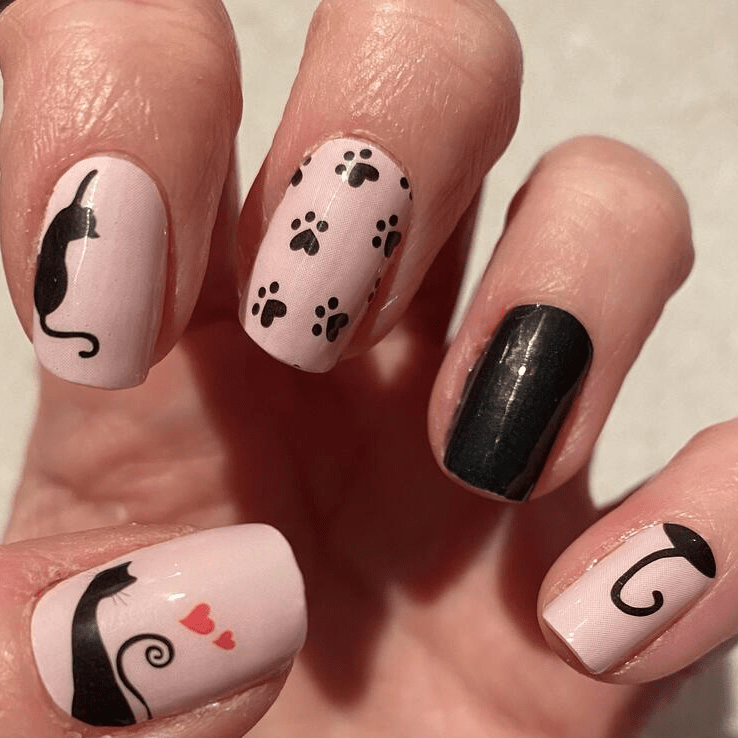 Cat themed gel nail wraps in pink and black with paw prints