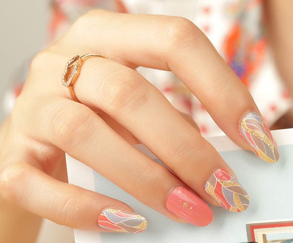 Non-UV nail wraps featuring coral and gold metallic feather art nouveau design on fingernails