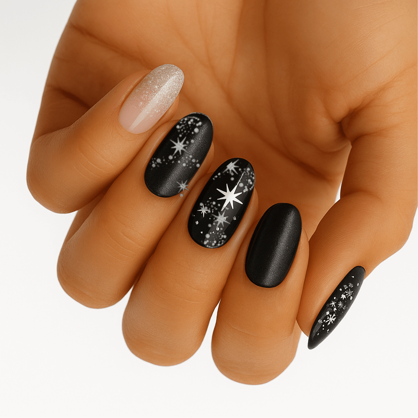 Black and silver glitter nail wraps with star patterns on hand showing celestial nail art