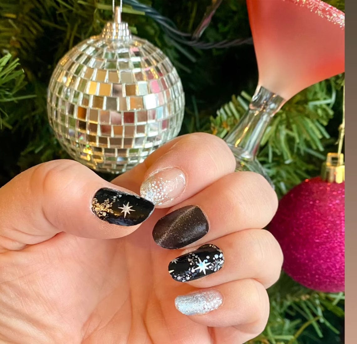 Festive nail wraps on hand with black silver star design perfect for party manicure
