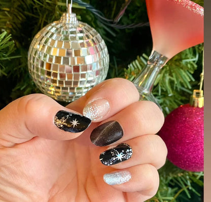 Festive nail wraps on hand with black silver star design perfect for party manicure