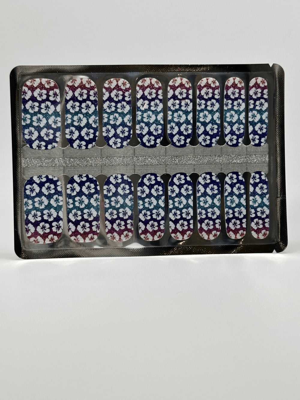 Non-UV nail wraps sheet showing purple floral hibiscus pattern with gradient sunset colours