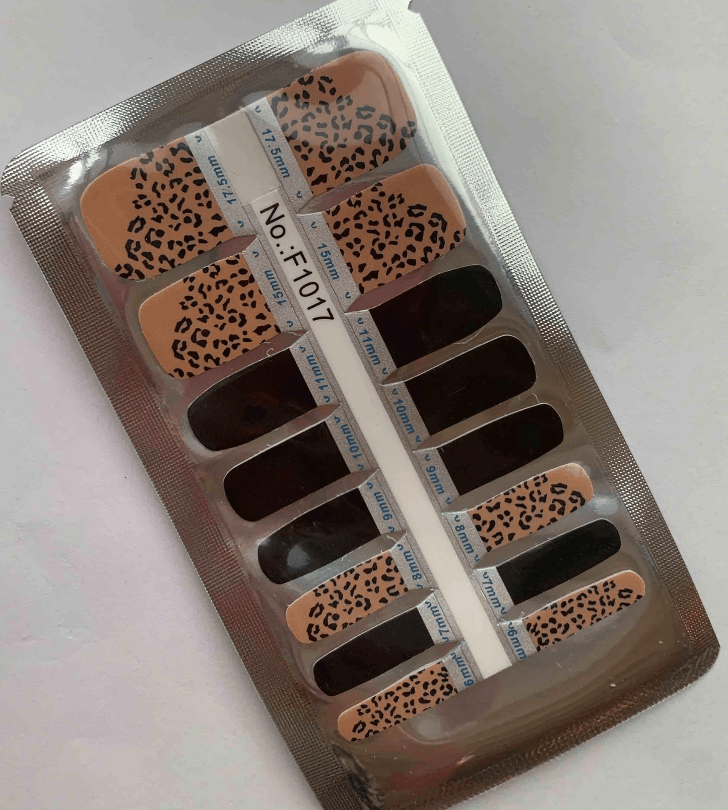 Non-UV pedicure nail wraps in leopard print pattern with nude base and black spots