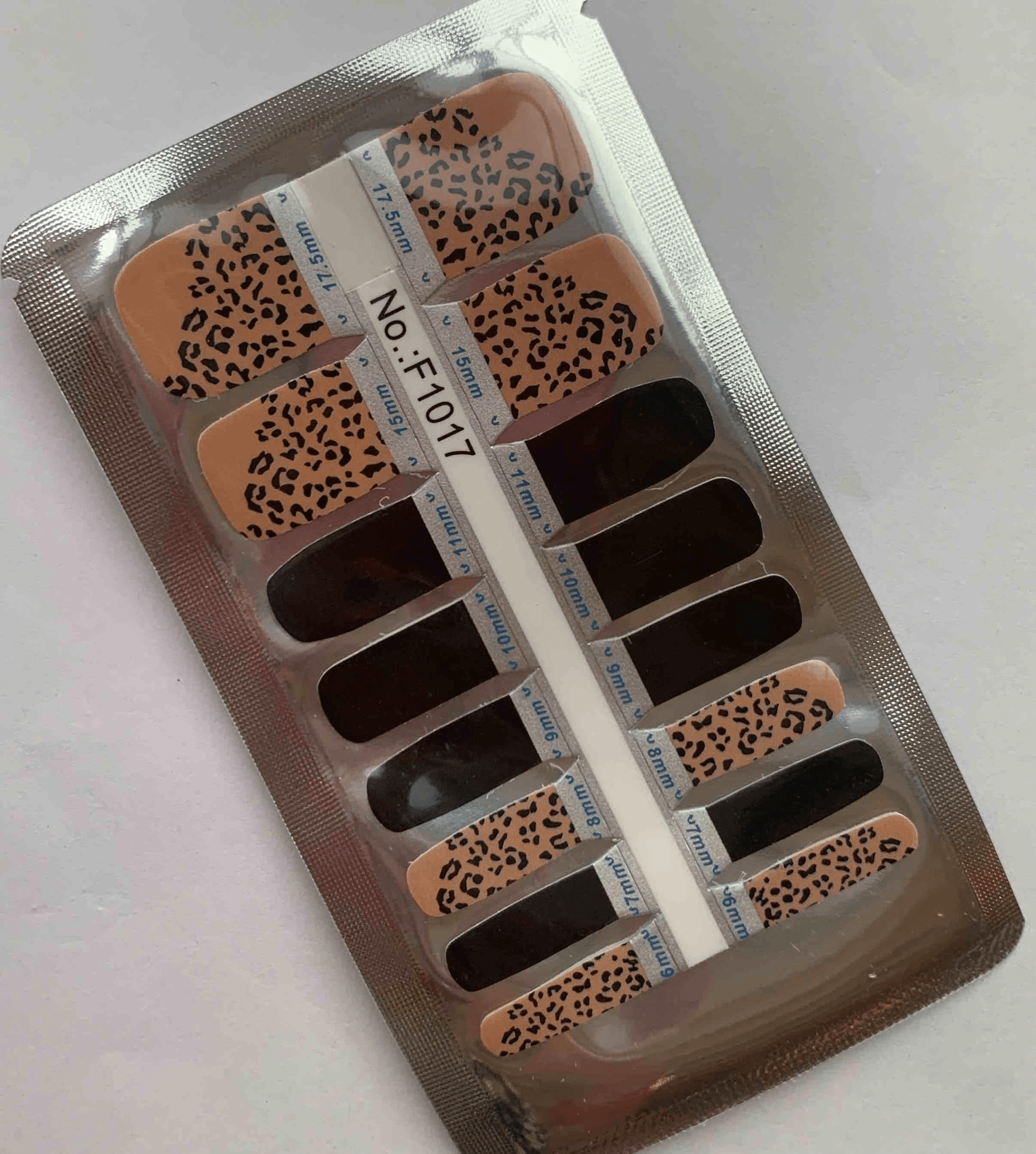 Non-UV pedicure nail wraps in leopard print pattern with nude base and black spots