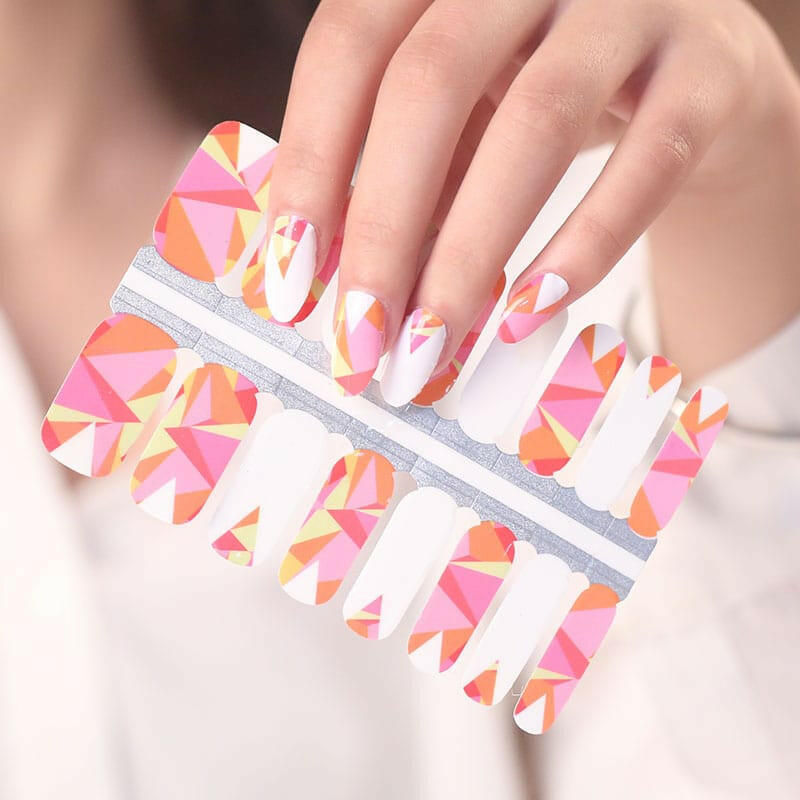 Non-UV nail wraps sheet showing geometric pink coral orange triangular pattern designs for DIY nails