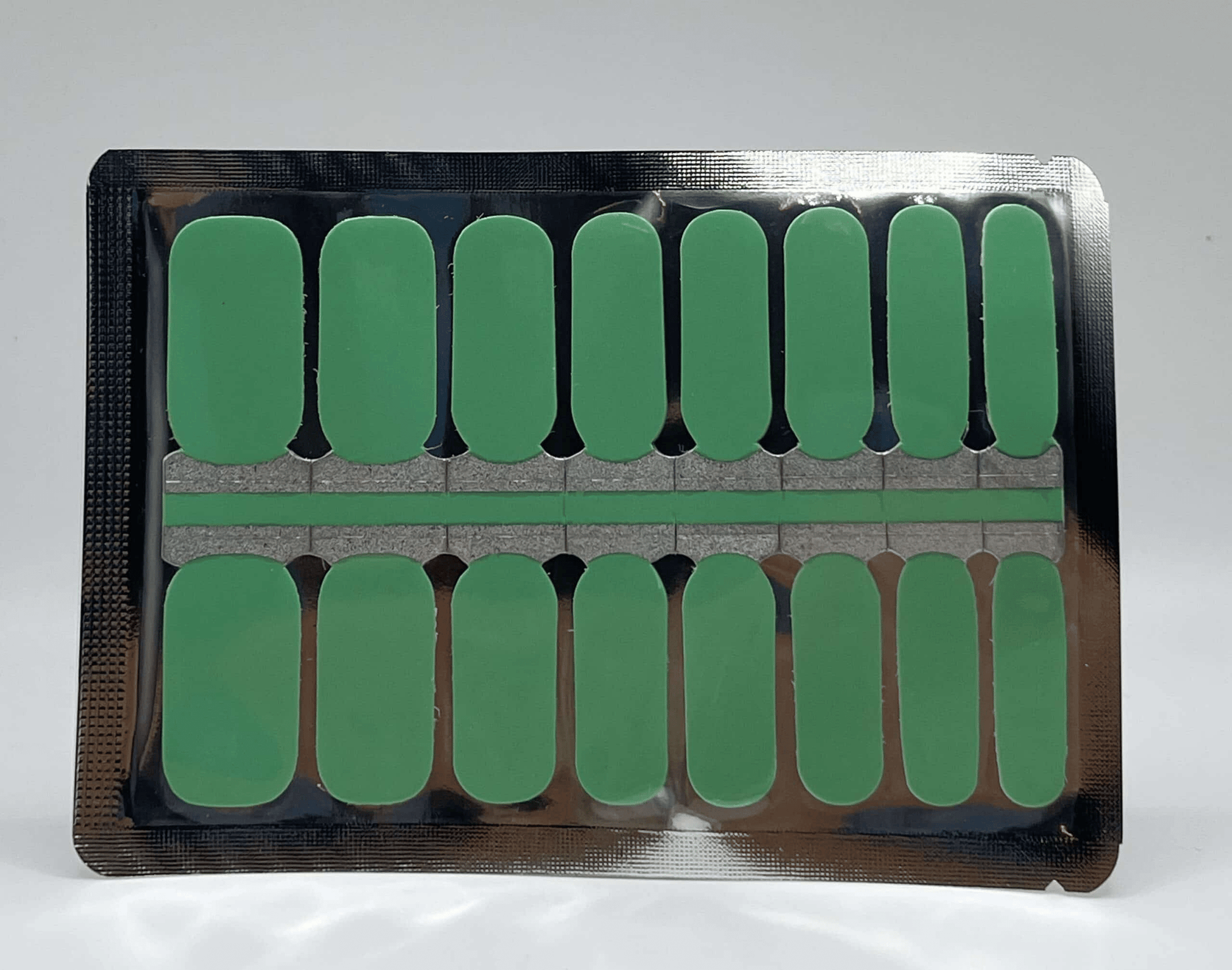 Seafoam green nail wraps sheet showing 16 solid colour adhesive nail strips
