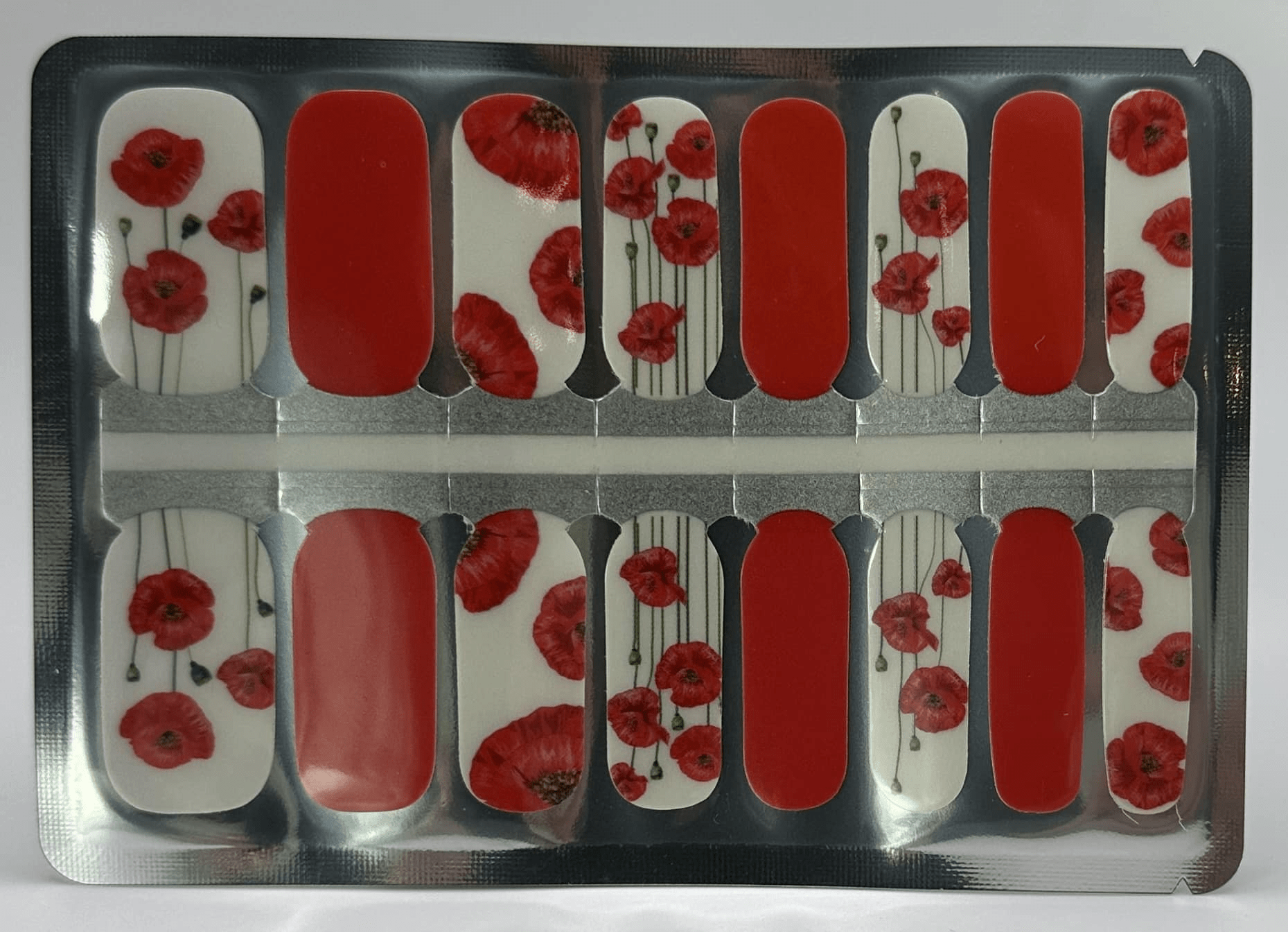 Red poppy floral nail wraps with white background in classic manicure design