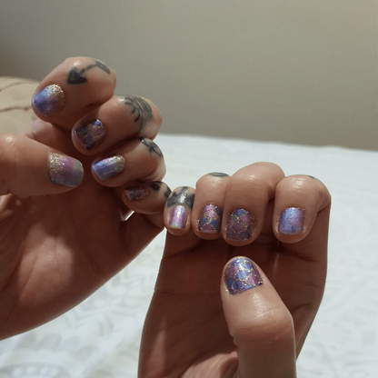 Shimmery purple and blue scale pattern nail wraps on both hands manicure