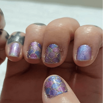 Iridescent purple nail wraps with mermaid scale pattern on hand close-up