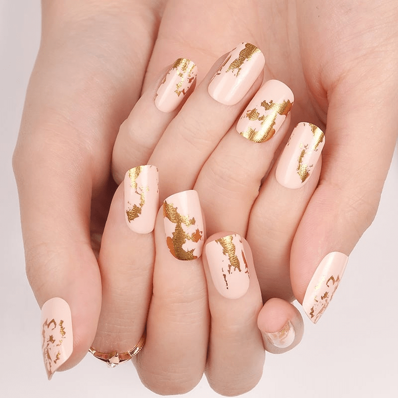 Champagne nail wraps with gold foil pattern on natural nails
