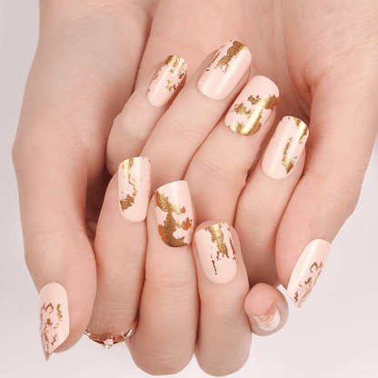 Champagne nail wraps with gold foil pattern on natural nails