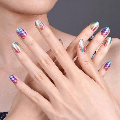Two hands showcasing rainbow swirl nail wraps with bold multicoloured psychedelic pattern nail art