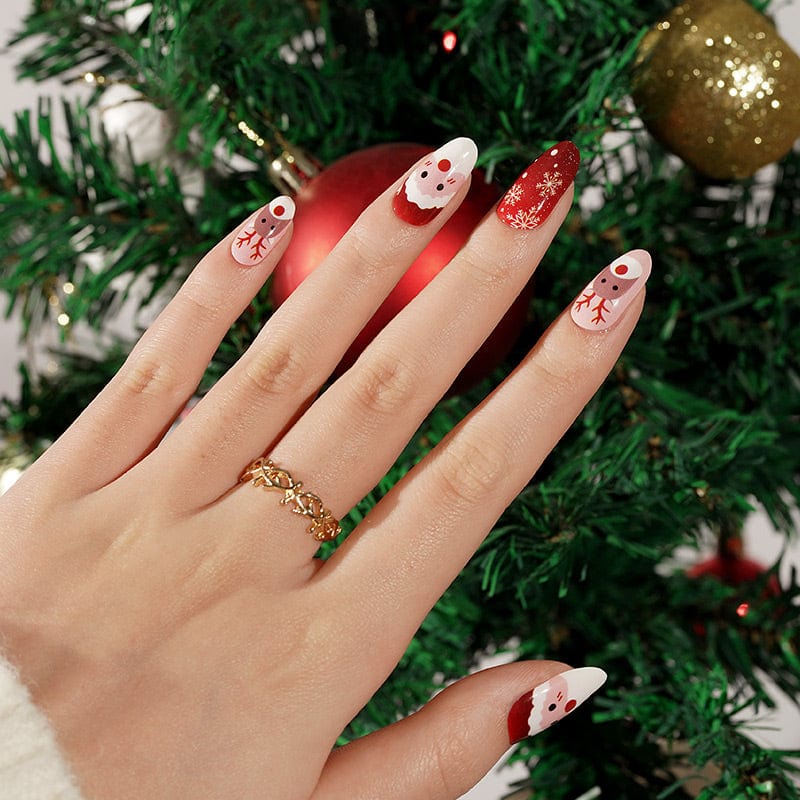 Christmas nail wraps on hand featuring Santa faces, reindeer and red glitter designs