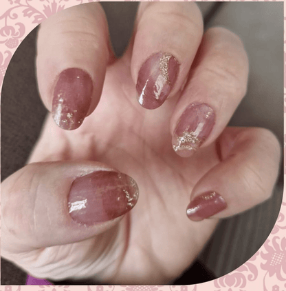 Rose quartz nail wraps with champagne foil accents on natural nails manicure
