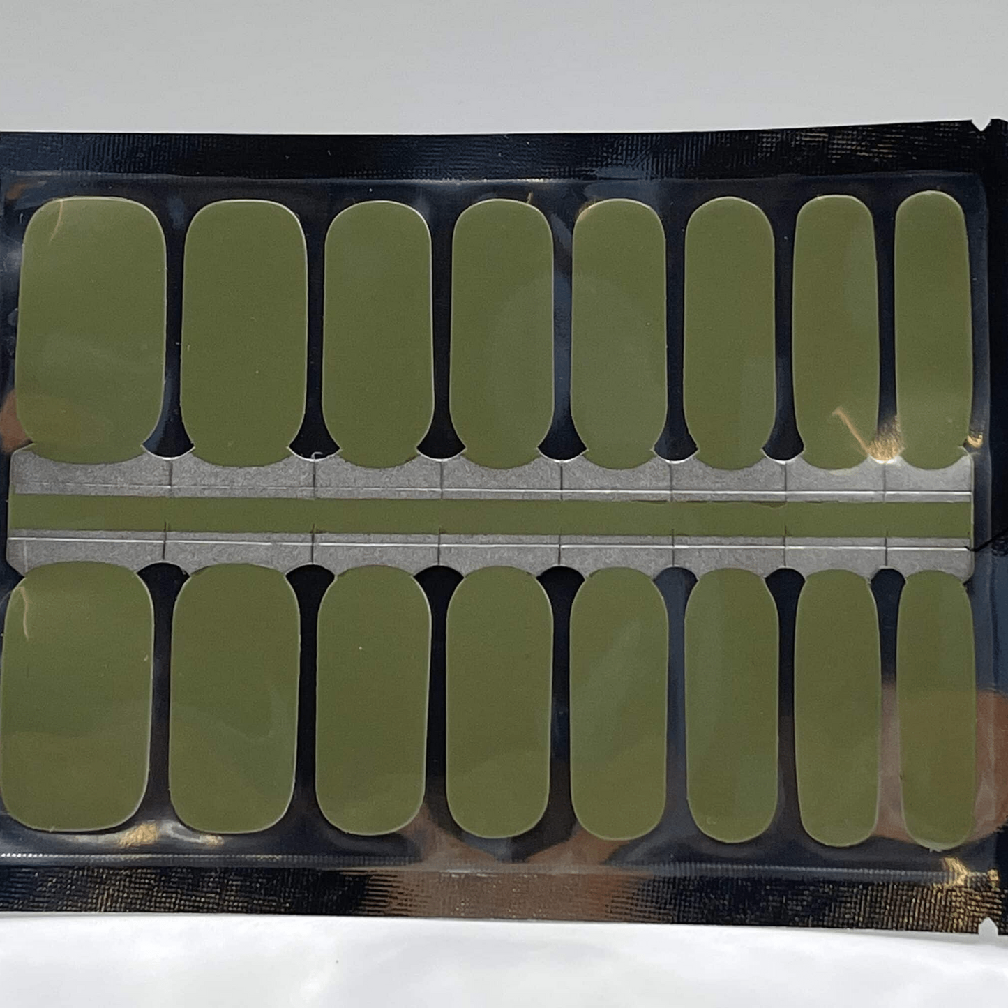 Sheet of sage green non-UV nail wraps showing multiple sizes for DIY manicure