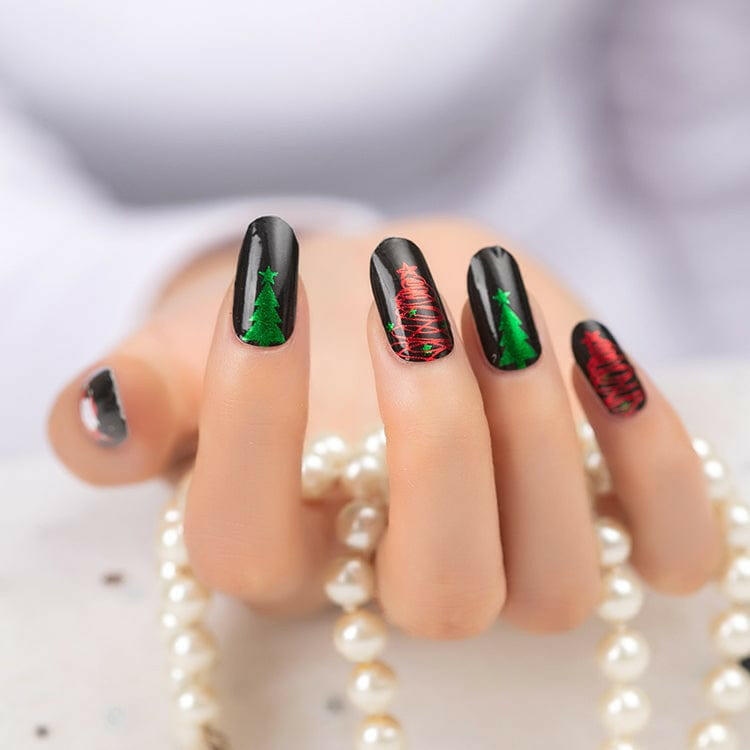 Black gloss nail wraps with green and red Christmas tree designs and stars
