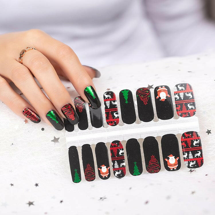 Christmas nail wraps sheet with Santa and festive designs in black, red and green
