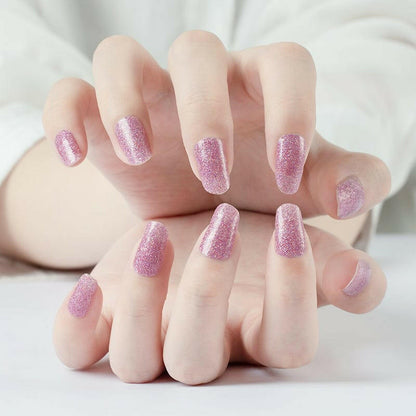Pink glitter non-UV nail wraps displayed on both hands with sparkly mauve finish