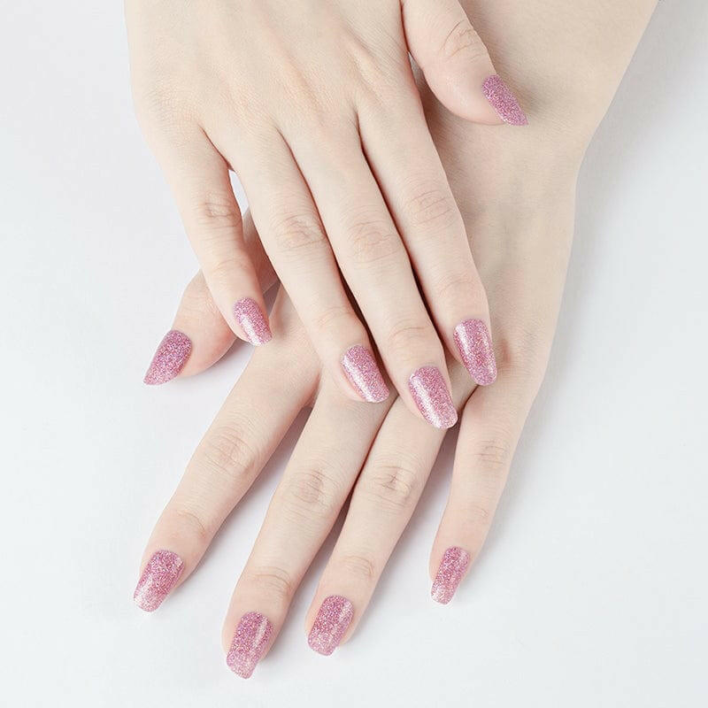 Rose gold sparkle nail wraps displayed on hands with metallic pink glitter finish
