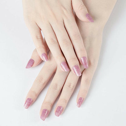 Rose gold sparkle nail wraps displayed on hands with metallic pink glitter finish